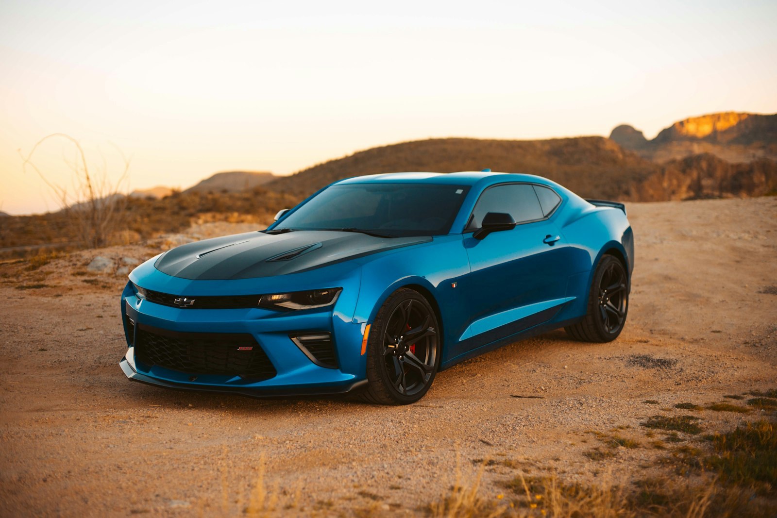 Red sports car angled at three-quarter view, hotspots to explore car care by part
